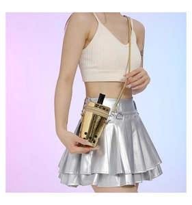 Detail of creative gold milk tea cup shaped crossbody bag with chain strap and laser finish