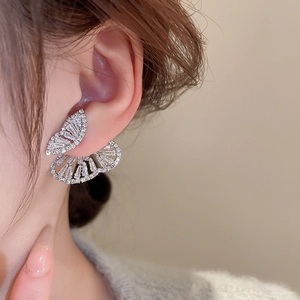 Close-up of sparkling zircon butterfly earrings worn on model for elegant bridal style