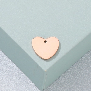 Minimalist heart-shaped rose gold pendant on a display stand for a classic necklace look