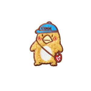 Cute yellow bird embroidered patch with blue cool hat and red bag on white background