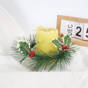 Close-up of Christmas candle ring with pine needles, red berries and holly leaves