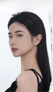 Close-up of a multi-layer S925 silver ear cuff worn on the cartilage by a female model