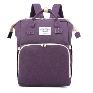 Front view of purple multi-functional diaper bag with wide handles and metal zippers