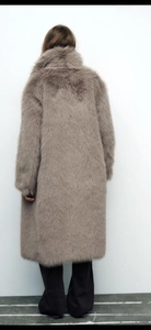 Back view of a long faux fur coat in taupe grey showing the thick plush texture and silhouette