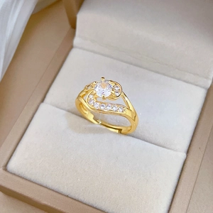 Adjustable gold plated wave ring featuring a central round diamond and side zircon accents