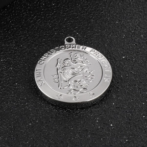 Macro view of Saint Christopher medal engraved on a solid stainless steel pendant