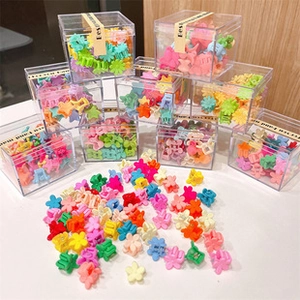 Bulk set of colorful mini flower and star hair clips in transparent storage boxes