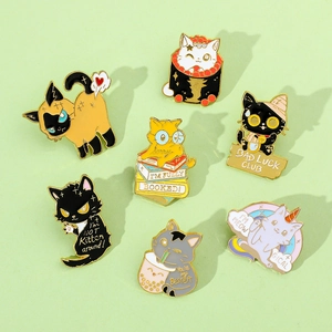 Detailed flat lay of seven distinct cartoon cat enamel pins on a light green background