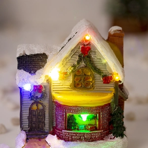 Detail of light-up Christmas snow house with multi-color LED lights and snowy texture