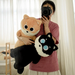 Detailed view of large plush shiba inu dog dolls in brown and black soft fabric