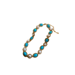 Vintage jewelry set with turquoise beads and white pearls on a gold chain