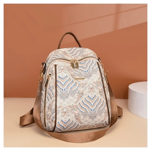 Close-up of beige New Chinese style backpack with blue wave embroidery and gold hardware