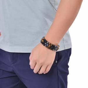 Detail of 8mm tiger eye, obsidian and hematite triple layer beaded bracelet on wrist