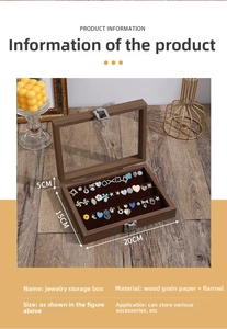 Detail view of walnut wood jewelry box with glass lid showing ring slots and metal clasp