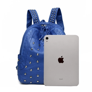 Royal blue pebble leather backpack with silver rivets and iPad size comparison