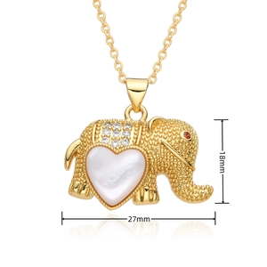 Detailed view of a gold elephant pendant with white heart shell and small diamonds