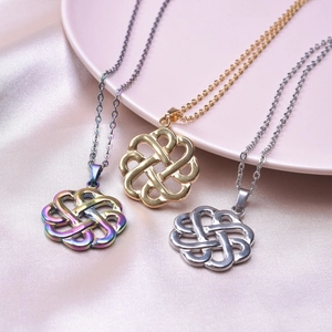 Macro detail of stainless steel witch's knot pendants in gold, silver, and rainbow finishes