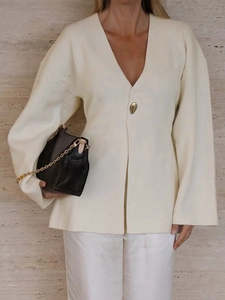 Detail view of cream white V-neck ribbed knit cardigan with elegant lantern sleeves
