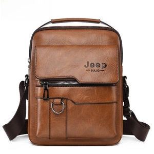 Macro detail of brown leather messenger bag with flap pocket and metallic D-ring