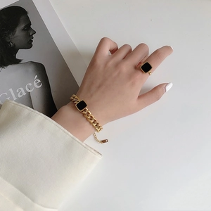Golden chunky Cuban link bracelet and black square signet ring set for women