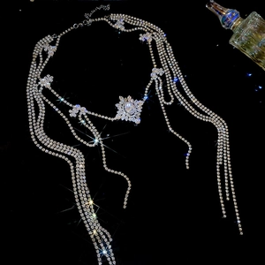 Close-up of luxury silver-toned tassel necklace with zircon floral accents and long chains