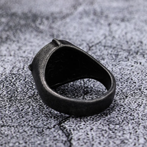 Vintage punk viking compass cross ring in dark grey finish on stone texture