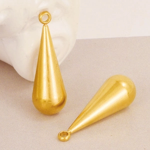 Detail of two golden teardrop pendants with polished finish for DIY jewelry necklaces