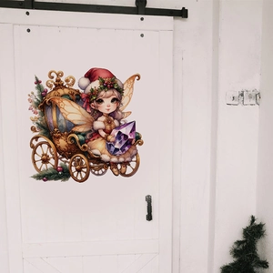 Detail of Christmas fairy wall sticker with pumpkin carriage on a white wooden door