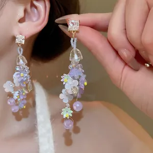 Sparkling silver needle flower tassel earrings with purple beads for beach vacation look