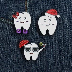 Three-piece dental enamel pins set on denim fabric featuring cute cartoon tooth designs