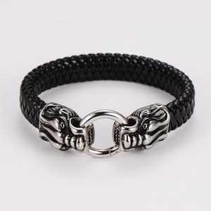 Detail of vintage braided leather bracelet featuring double silver lion head metal clasps