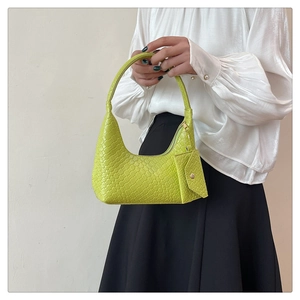 Close-up of woven texture on lemon green shoulder bag with small detachable coin purse