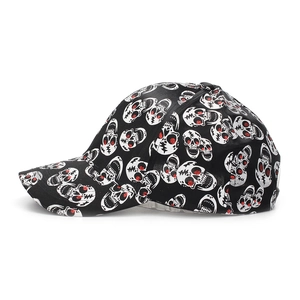 Detail of black baseball cap featuring white skull print and red glitter eye accents