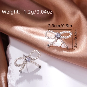 Detailed view of pearl bow earrings with size measurements of 2.3cm and 1.5cm