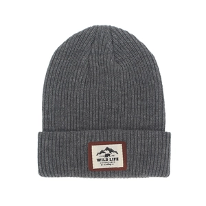 Close-up of the dark grey ribbed knit beanie showing the outdoor mountain patch detail