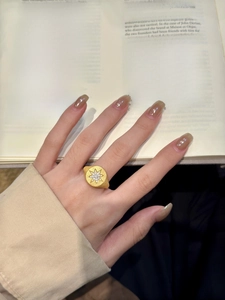 Macro detail of gold-plated starburst ring with matte finish and white zircon stones
