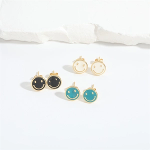 Three pairs of smile face enamel stud earrings in black, white, and lake blue colors