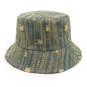 Detailed view of distressed denim bucket hat featuring vintage stripes and ripped texture