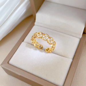Adjustable gold clover ring with pavé crystals in a luxury velvet jewelry box display