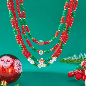 Christmas layered beaded necklace with Santa charms and HOHO lettering on green background