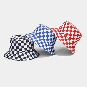 Close-up of checkered bucket hats in black, blue, and red patterns on gray background