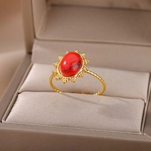 Detailed macro view of vintage gold ring with oval red turquoise in velvet box