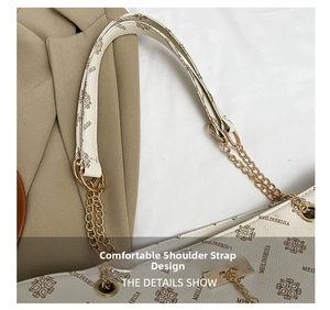 Detail view of the elegant chain and leather spliced shoulder strap on a tote bag