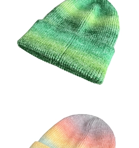 Close-up of thick knitted beanie with vibrant gradient tie-dye patterns and warm texture