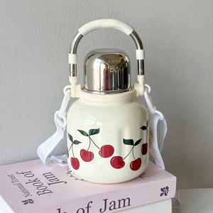 Detail of insulated stainless steel bottle with cherry print and adjustable strap