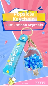 Detail of popsicle acrylic keychain with blue beads and D.oi BEAR silicone wrist strap