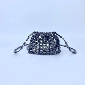 Close-up of gunmetal grey sequin woven bag with metallic oval beads and shoulder strap