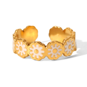 Macro detail of golden stainless steel open ring with white daisy floral enamel design