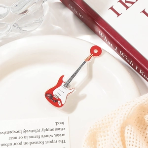 Detailed macro view of an acrylic guitar-shaped hair clip in red and white colors