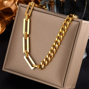Polished gold Cuban link and rectangular chain necklace shown on a luxury jewelry box